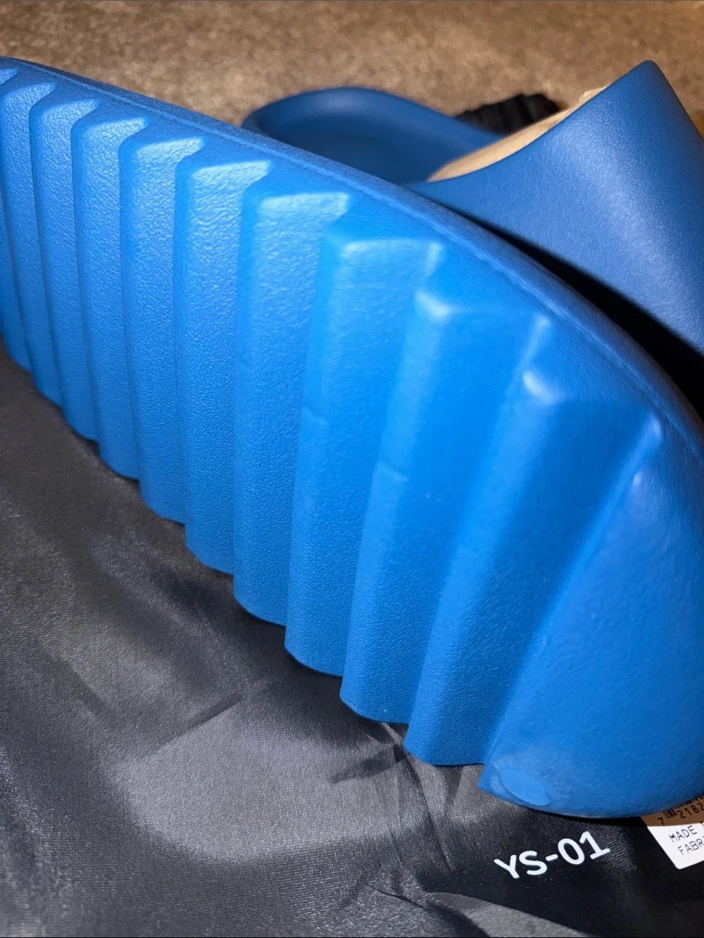 foam runner/slides inspired by Yeezy‎ designs. The bag says “YS-01,”